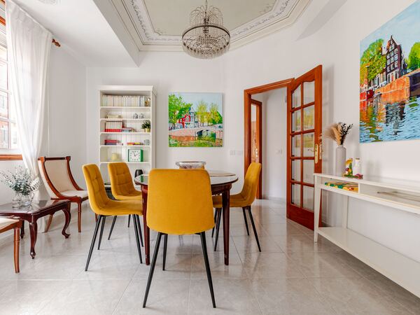 Dining area with velvet chairs — De Villa Suites